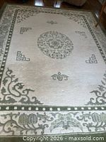 Full view of cream and green area rug