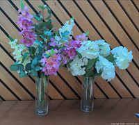 Both artificial flower arrangements side by side