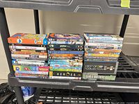 Four stacks of DVDs on shelf showing variety of cases
