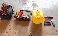 Overall lot showing two roadside kits, yellow gas can, ice scrapers