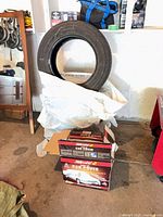 Tire upright, car cover boxes and loose cover visible