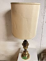 Full view of brass lamp with shade