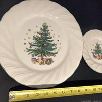 Dinner plate showing Christmas tree design with measuring tape for scale