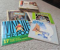 Stack of children’s LPs with Winnie-the-Pooh, Baby Beluga, Mr. Dressup and others visible