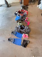 lot overview showing flippers, boots, weights, snorkels, dry bag spread on floor
