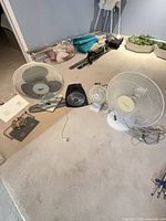 Lot overview showing two large fans, small fan, heater, lamp