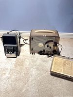 Argus editor-viewer and Brownie projector side by side on floor