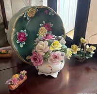 Front view showing Nippon plate, Royal Adderley pot, Coalport log piece, Capodimonte basket