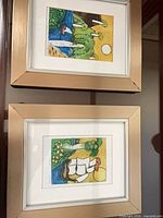 Both framed artworks hanging vertically