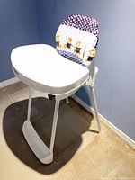 Front view showing tray, seat cushion pattern, and legs