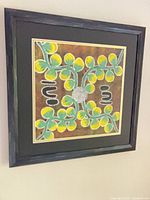 Frontal view of framed square dot art canvas