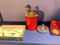 Wide shot showing piggy bank, ring holder, coin case, jewellery box