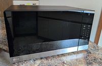 Front and side view of LG microwave on countertop