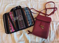Overview of both items: red purse and multicolour laptop sleeve