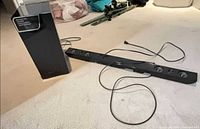 Soundbar and subwoofer on carpeted floor