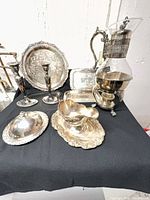 Full group view of all seven silver-plated serving pieces