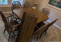 table, six chairs around it, window behind