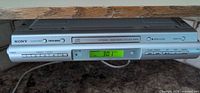 Front view of Sony ICF-CDK50 mounted under cabinet showing LCD display and controls