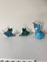 All three stained glass angel figurines grouped