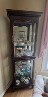 Full view of the tall curio cabinet showing both compartments and overall design