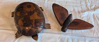 Both carved wood items turtle box and moth wall hanging displayed together