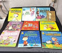 Group shot of nine record books laid out 3×3 showing all titles