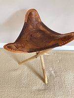 Overall view of stool showing leather seat and bamboo legs