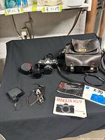 Full lot overview showing camera with lens, additional lens, flash, case, manuals