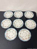 Eight matching Mintons plates arranged on surface