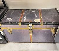 Front view showing overall trunk, latches, color, wear
