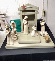 Full nativity set arranged on base with creche and all figures