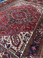 Oblique view showing red field, beige corners, border detail