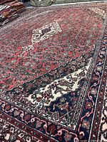 Angled close-up showing pile, border, and corner design