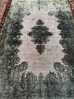 Full view showing central medallion and faded light red field