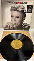 Front sleeve with portrait of David Bowie and visible vinyl record