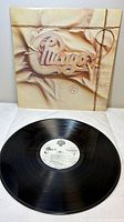 Front cover and vinyl record displayed