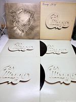 Full set showing outer slipcase and four LP sleeves with records partially visible