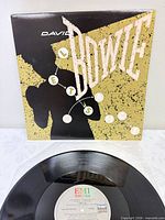 front of picture sleeve with stylized silhouette and Bowie lettering, vinyl partially shown