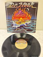 Front jacket artwork and vinyl record displayed