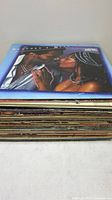 Stack of vinyl LPs, top album showing couple embracing