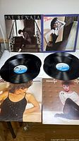 Four Pat Benatar album jackets and two loose records displayed