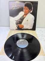 Front jacket with vinyl record and lyric sleeve visible