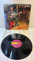 Front cover and vinyl record visible
