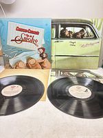 Front jackets and vinyl discs for both albums visible