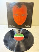 Front cover of Phil Collins 'No Jacket Required' album and vinyl disc