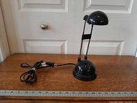 Full view of IKEA Espressivo desk lamp showing base, telescopic arms, shade and cord