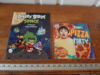 Both books side by side with ruler for scale