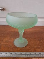 Full frontal view of frosted green diamond point compote on ruler for scale