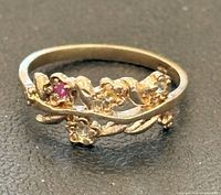 Top view of sterling silver ring showing floral leaf motif and stones