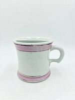 Side view showing body, handle and pink lustre bands
